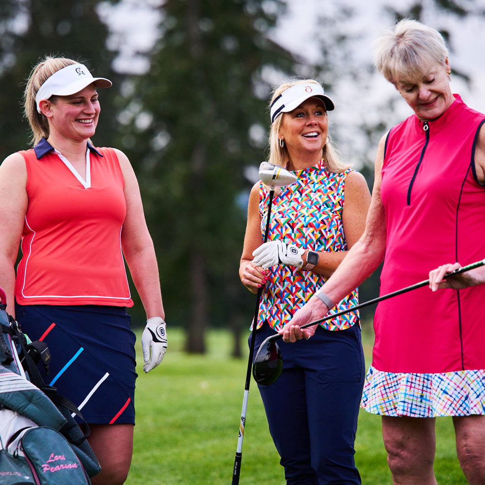 Three happy women in putting green in KINONA’s original women’s golf fashion. 