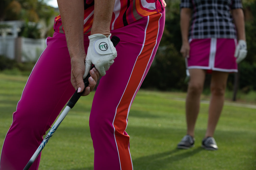 A woman wearing pink pants with an orange side panel