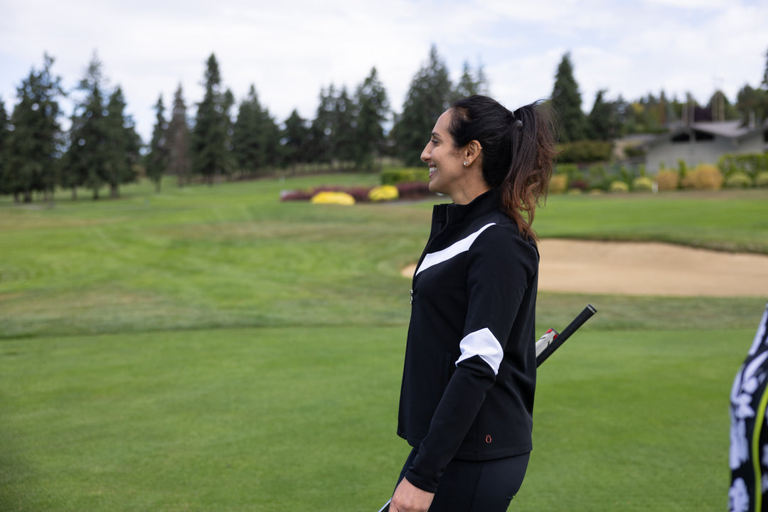 A woman wearing a black long sleeved jacket