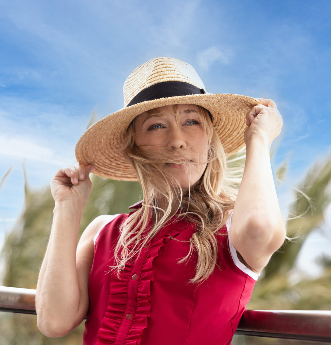 Woman wearing a hat and red dress