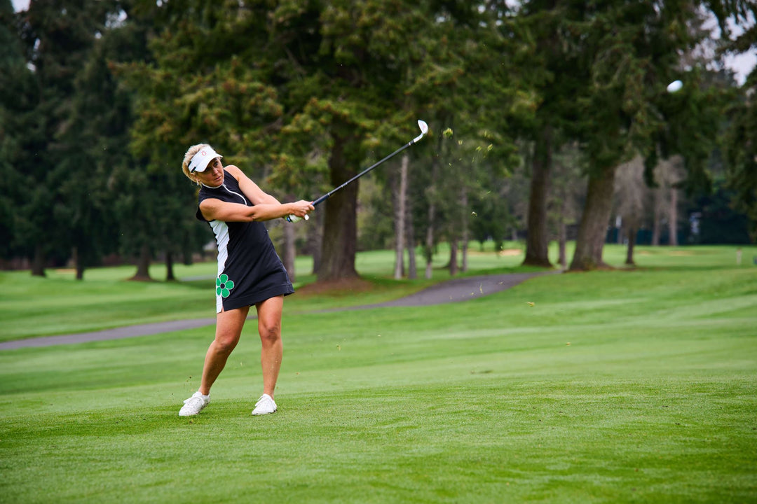 image of women golfing in a black dress