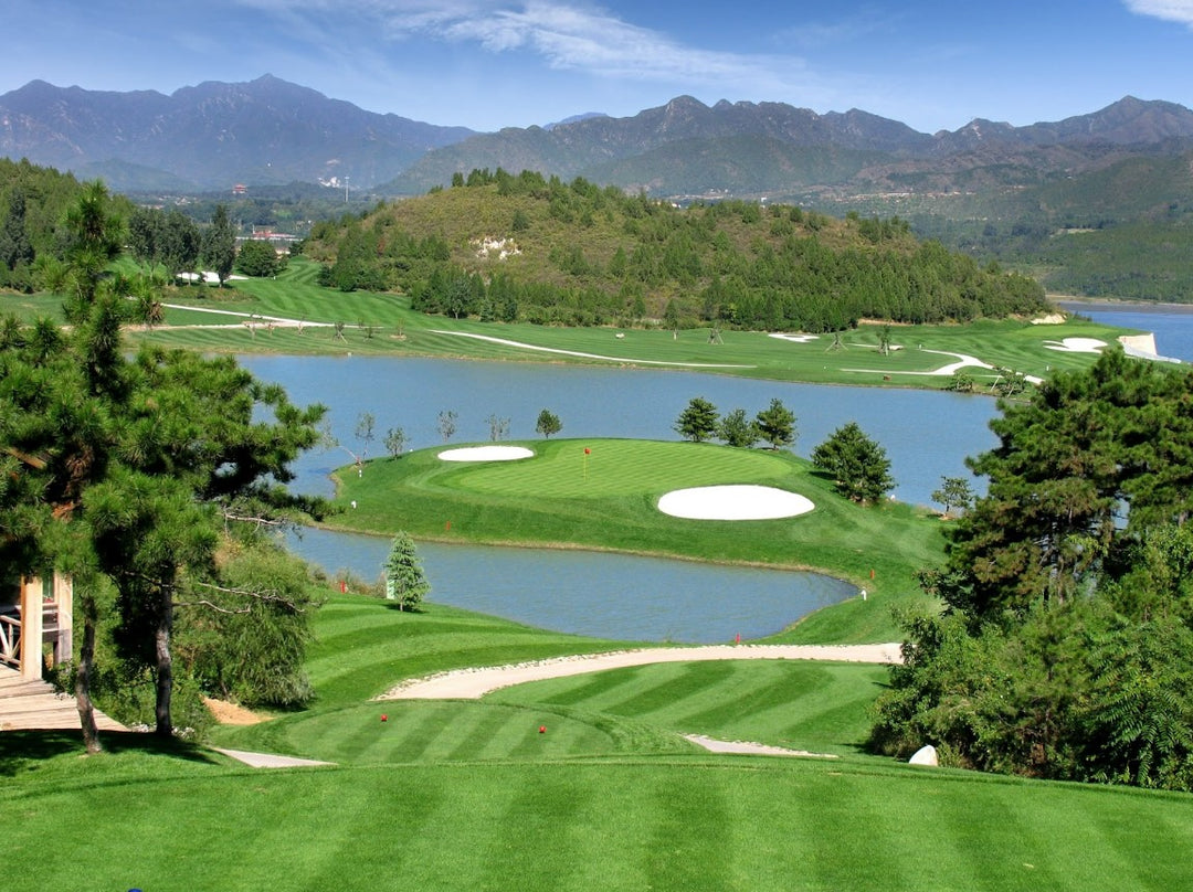 A beautifully landscaped golf course, with a body of water