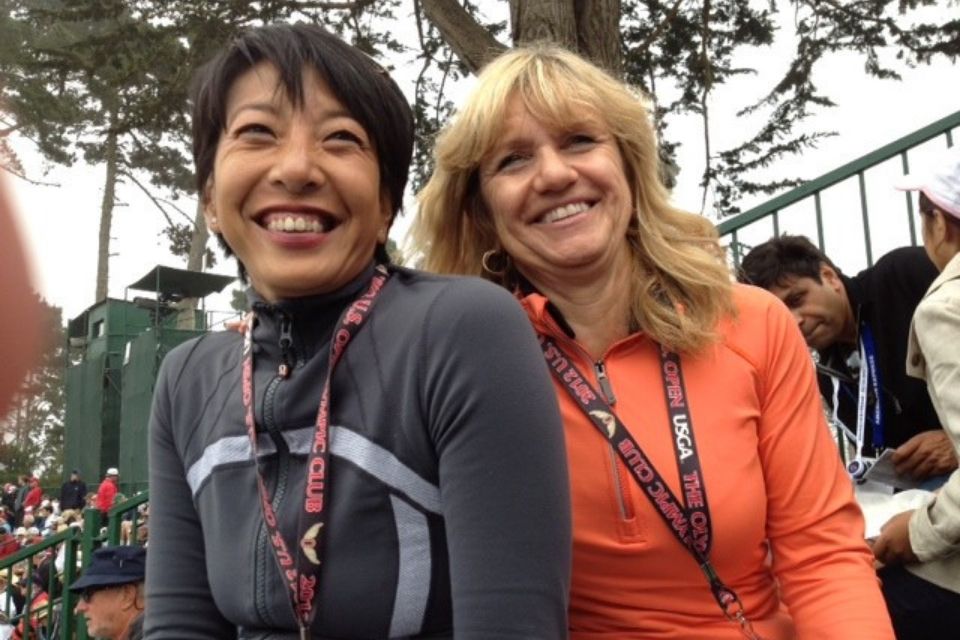 Female Founders, Tami and Dianne smiling together sitting at a golf event.