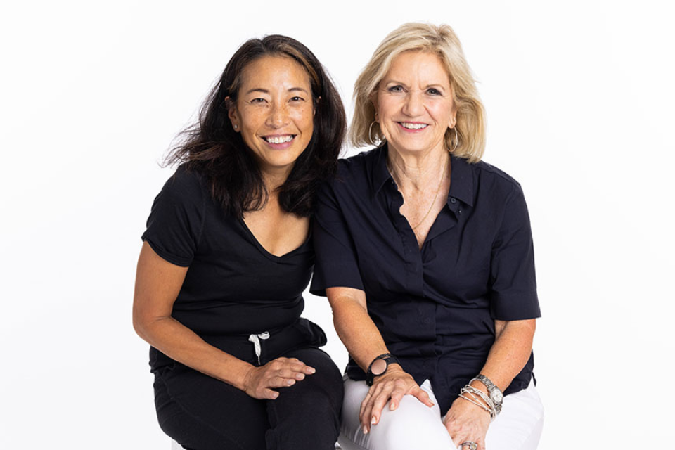 KINONA female founders and friends Tami Fujii and Dianne Celuch smiling together.