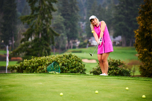 A woman swinging a golf club