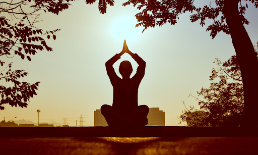 A silhouette of a person practicing yoga 