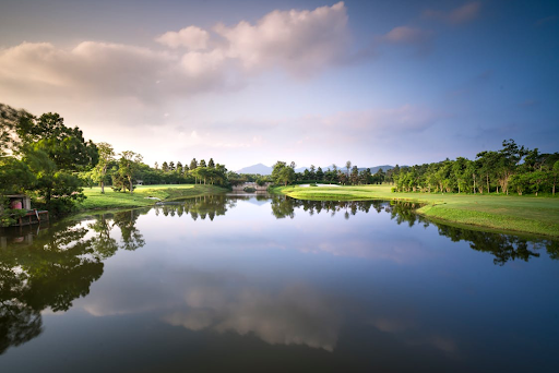 A golf course with a body of water 