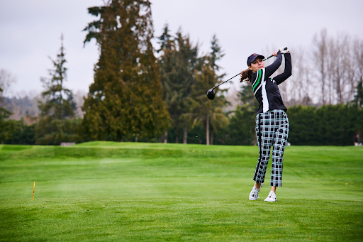 A woman taking a swing on the golf course