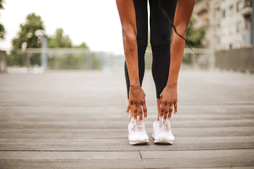 A woman touching her toes while stretching