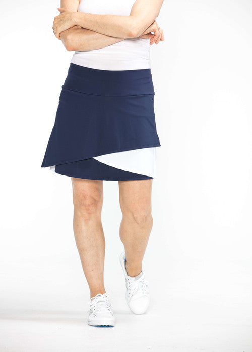 Woman wearing navy blue and white Wrap It Up golf skort