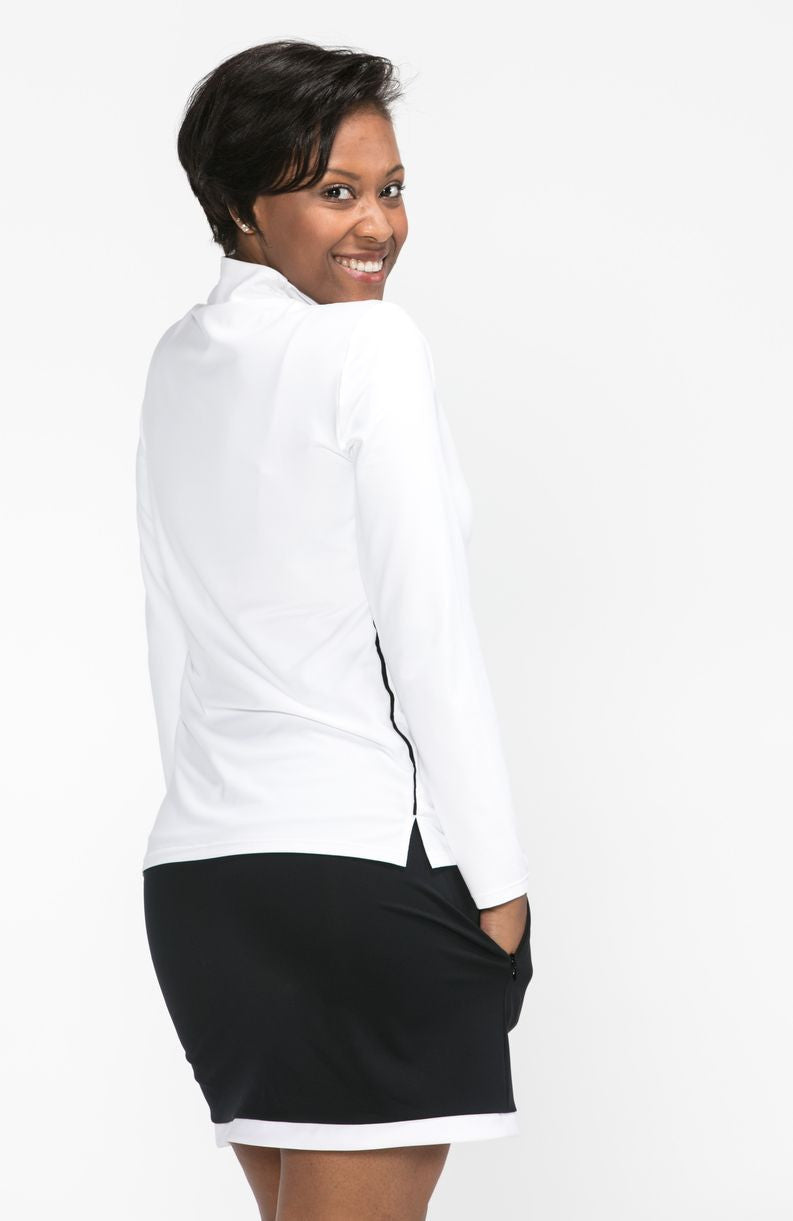 Back view of woman wearing a white long sleeve Keep it Covered golf top