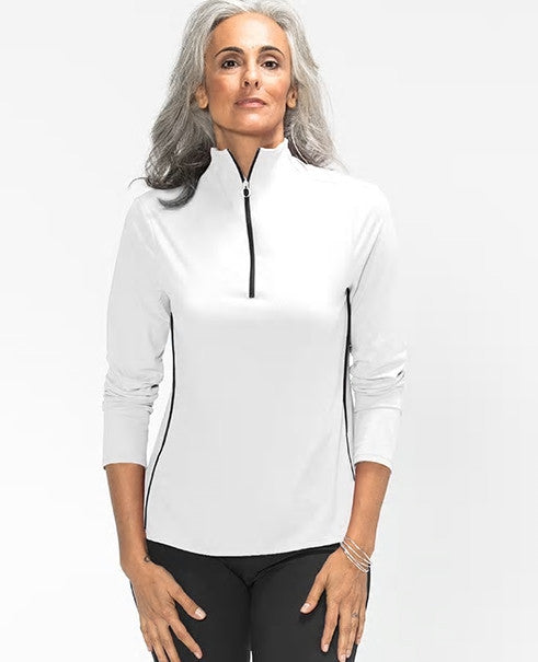 Woman wearing a white long sleeve Keep it Covered golf top