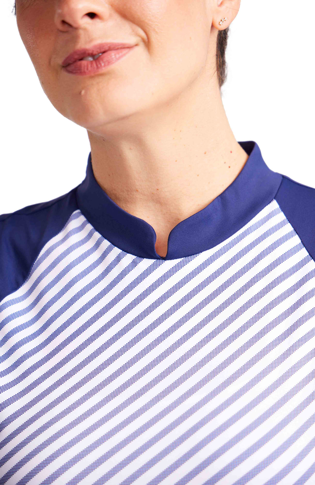 Close up view of woman in sleeveless top with blue and white stripe and navy shoulder and mock neck