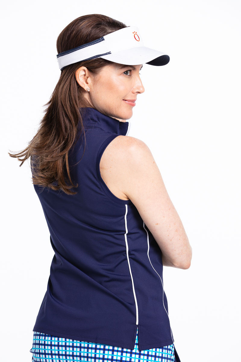 Woman golfer in navy blue Keep it Covered sleeveless golf top and white No Hat Hair visor