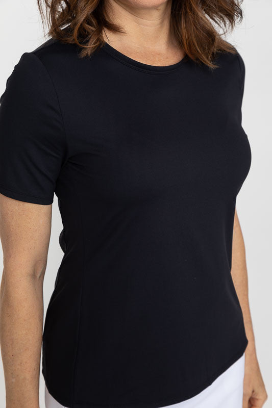Close front view of a woman wearing a Tee It Up Short Sleeve Golf Shirt in black