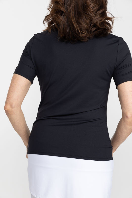 Back view of a woman wearing a Tee It Up Short Sleeve Golf Shirt in black