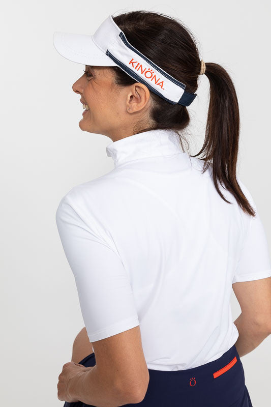 Back view of a woman wearing a Keep It Covered Short Sleeve Golf Top in white/white