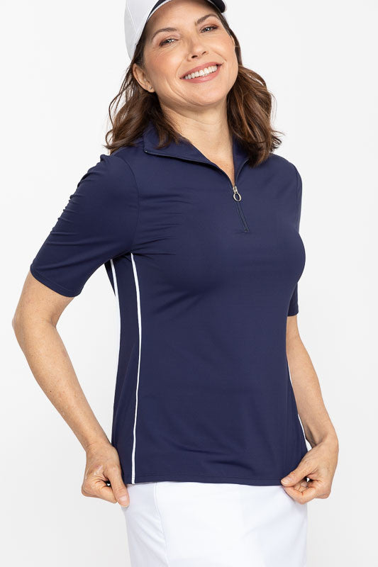 Front and right side view of a smiling woman wearing a Keep It Covered Short Sleeve Golf Top in navy blue