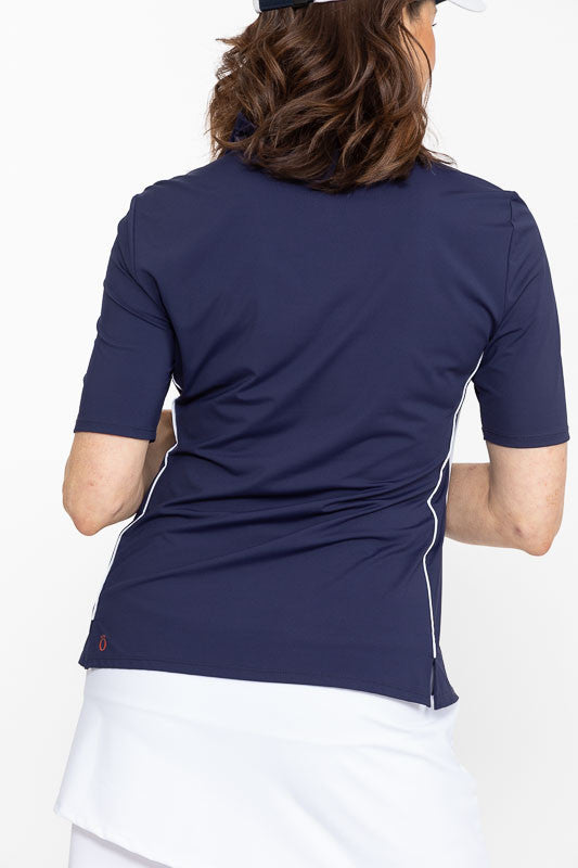 Back view of a woman wearing a Keep It Covered Short Sleeve Golf Top in navy blue