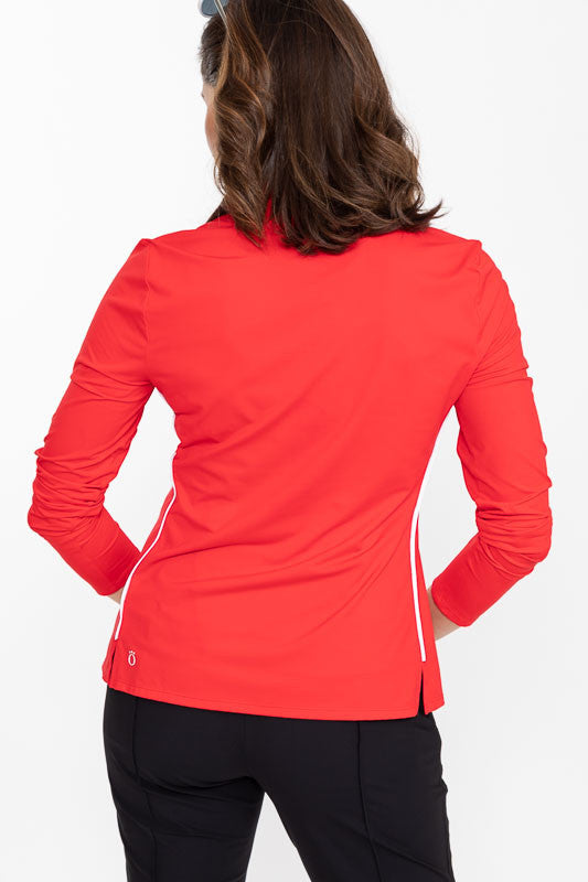 Back view of a woman wearing a Keep It Covered Long Sleeve Golf Top in Cherry Red