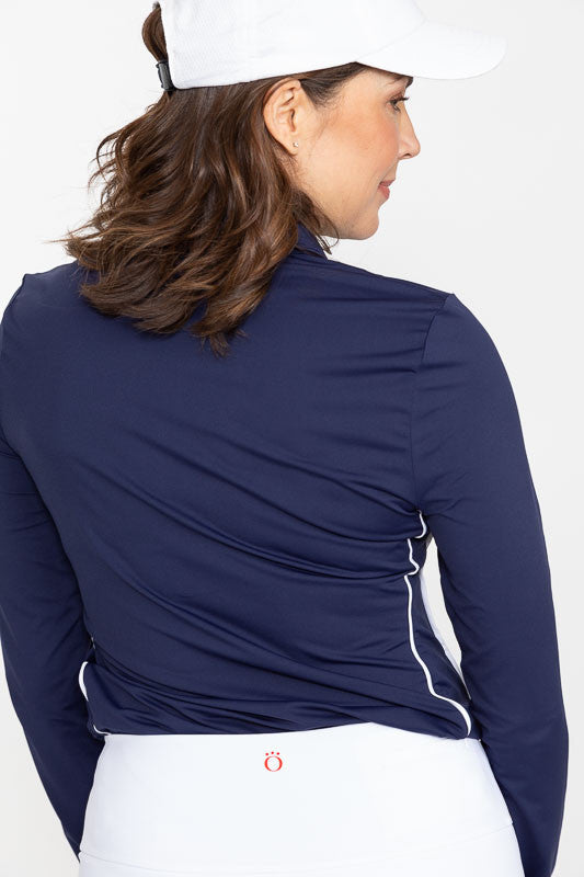 Back view of a woman wearing a white We've Got You Covered Hat and a Keep It Covered Long Sleeve Golf Top in navy blue