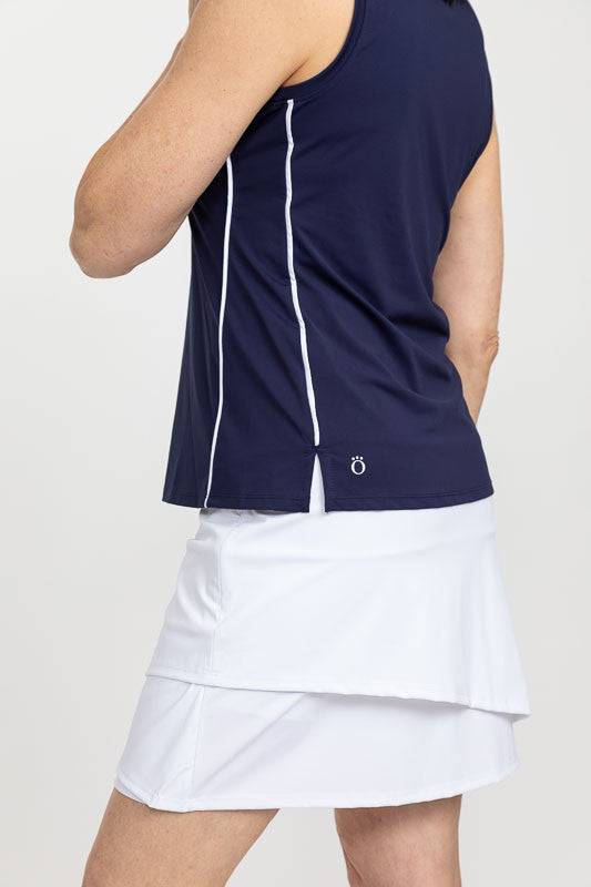 Side view of a woman wearing a Keep It Covered Sleeveless Golf Top in navy blue