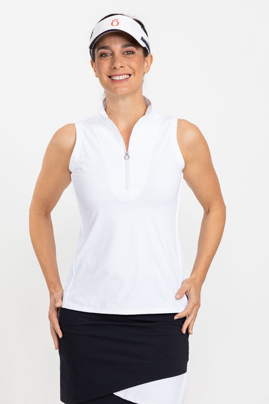 Full front view of a woman wearing a No Hat Hair Visor in white, a Keep It Covered Sleeveless Top in white/white, and a Wrap It Up Golf Skort in navy blue