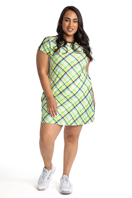 Full front view of a woman wearing the Pin High Short Sleeve Golf Dress in Picnic Plaid (plaid consists of green, yellow, navy blue, and white)
