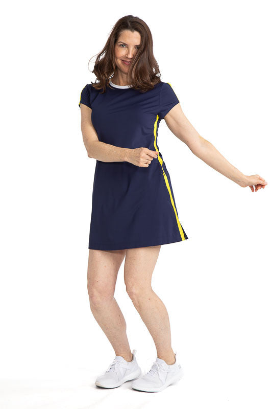 Full front view of a woman wearing the Pin High Short Sleeve Golf Dress in navy blue