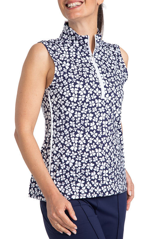 Front view of the Keep It Covered Sleeveless Golf Top in Vinca Print. The Vinca print has a navy blue background with white flowers on it.