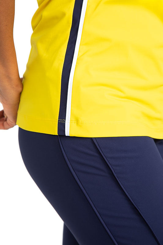 Close side view of the hemline on the  On Par Sleeveless Golf Top in Lemon Yellow. This shirt has navy blue and white accents at the V on the front of the shirt, and down each side, along with navy blue accents around each armhole. 