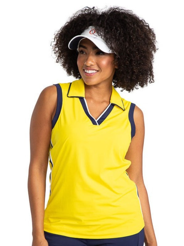 Smiling wearing the On Par Sleeveless Golf Top in Lemon Yellow and a No Hat Hair Visor in white. This shirt has navy blue and white accents at the V on the front of the shirt, and down each side, along with navy blue accents around each armhole. 