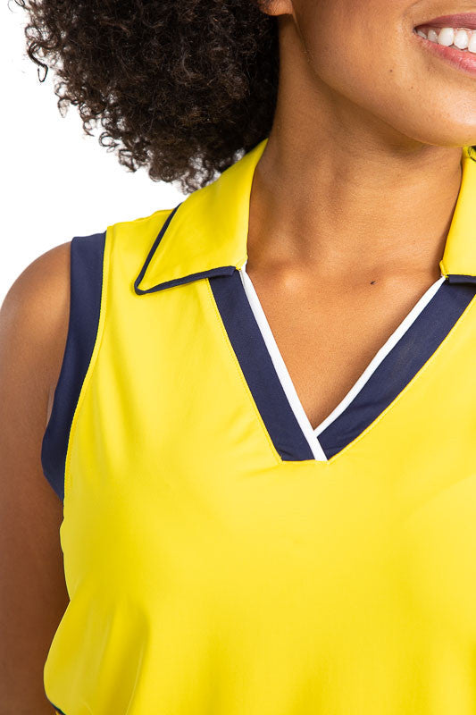 Close view of the neckline on the  On Par Sleeveless Golf Top in Lemon Yellow. This shirt has navy blue and white accents at the V on the front of the shirt, and down each side, along with navy blue accents around each armhole. 