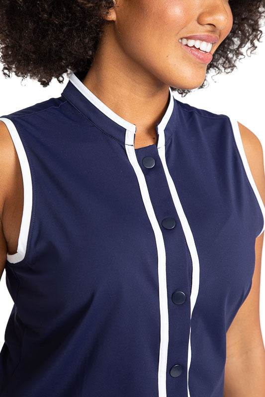 Closer front view of the neckline of the Looking Snappy Sleeveless Golf Top in Navy Blue. This top also has white accents around the collar and down the front of the top and around each armhole.