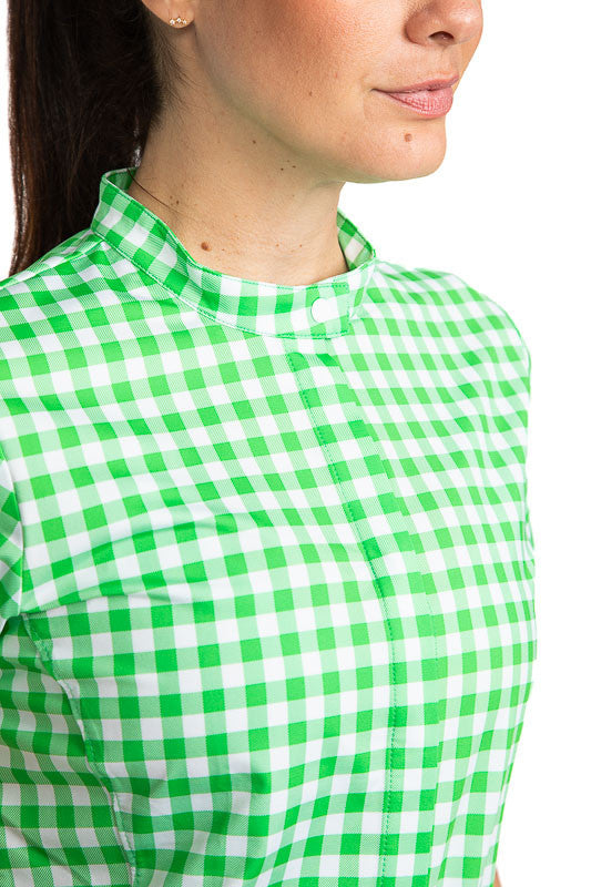 Close front view of the neckline and front of the Band Collar Beauty Short Sleeve Golf Shirt in Go Go Gingham. This print consists of green and white checks.