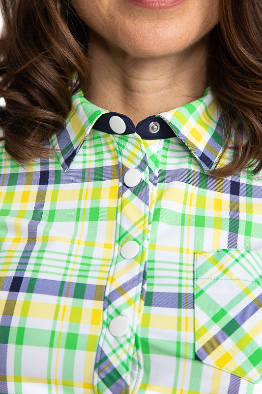 Close view of the neckline on the Tough in the Rough Short Sleeve Golf Top in Picnic Plaid. Picnic plaid consists of white, navy blue, green, and yellow. 