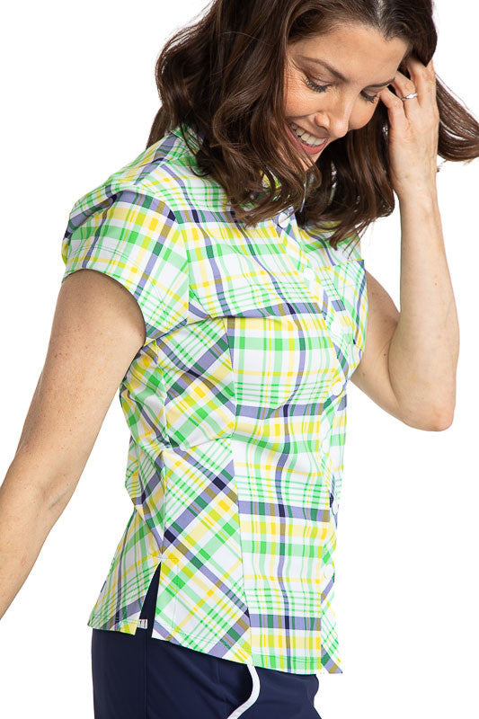 Woman wearing the Tough in the Rough Short Sleeve Golf Top in Picnic Plaid. Picnic plaid consists of white, navy blue, green, and yellow. 