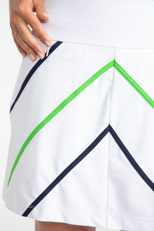 Close front and right side view of the Show Me The Way Golf Skort in White. This skort has accents in the form of two diagonal line on both sides of the front of the skort in Fairway Green and Navy Blue. There are also Navy Blue accents on each pocket on 