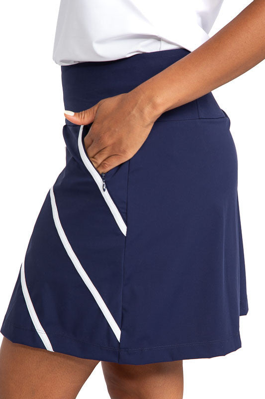 Left side view of the Show Me The Way Golf Skort in Navy Blue. This skort has accents of two white, diagonal stripes on the front only and a white stripe on each pocket.