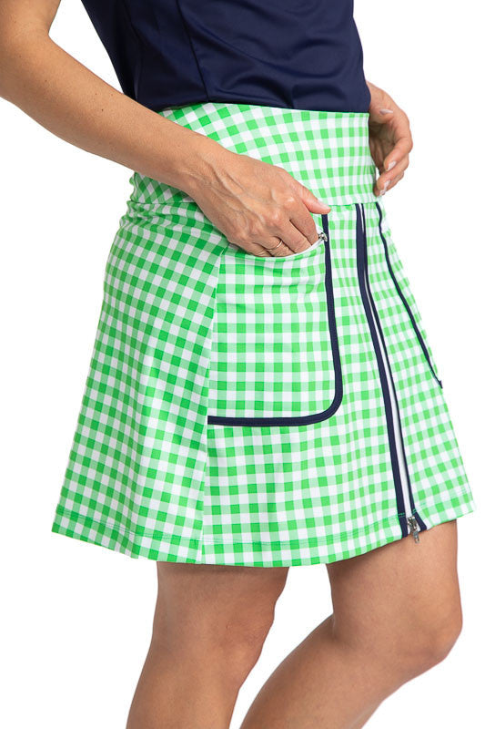Close right side view of the the Ready Play Golf Skort in Go Go Gingham. The Go Go Gingham print consists of green and white checks. This golf skort also has navy blue accents down the length of the zipper on both sides, a white front zipper, navy blue  c
