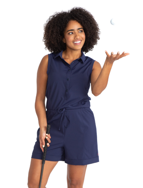 Front view of a woman wearing the Style For Miles Golf Romper in navy blue.  Women's navy blue golf romper.
