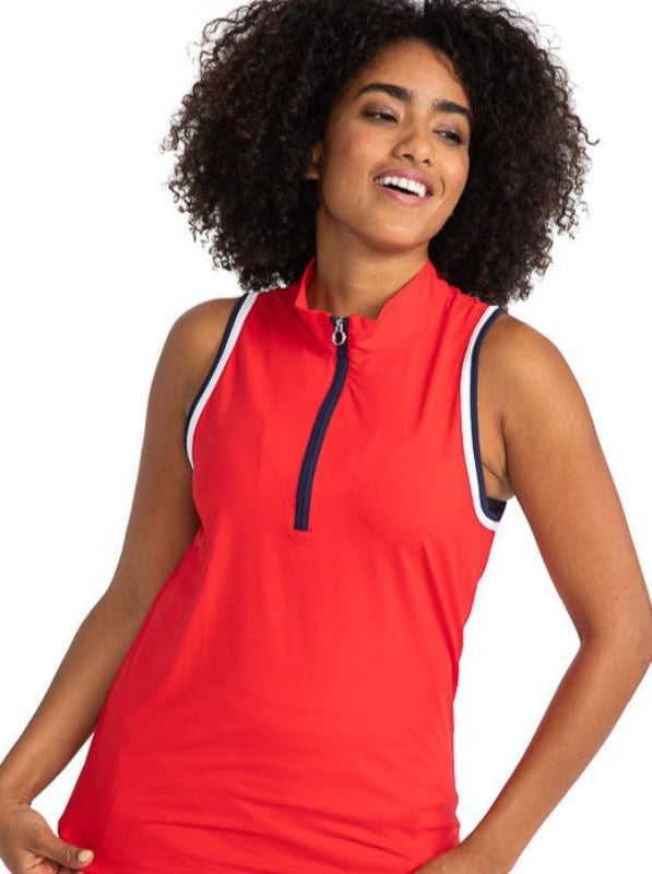 Complete front view of the Love the Sun Sleeveless Golf Top in Cherry Red. This top has navy blue and white accents around the sleeve and navy blue on either side of the front zipper.