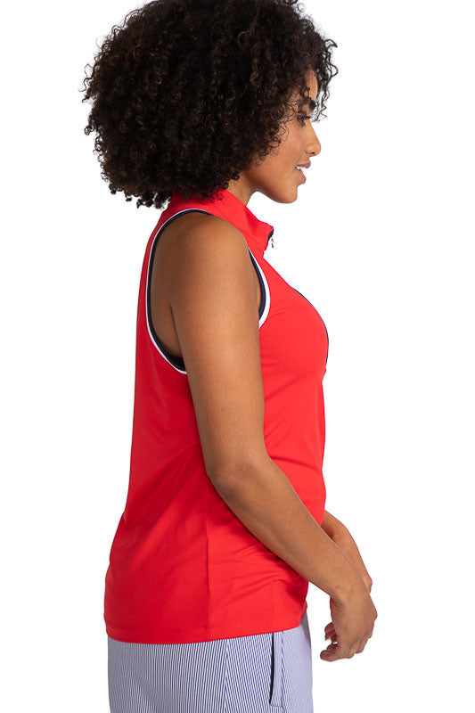 Complete right side view of the Love the Sun Sleeveless Golf Top in Cherry Red. This top has navy blue and white accents around the sleeve and navy blue on either side of the front zipper.