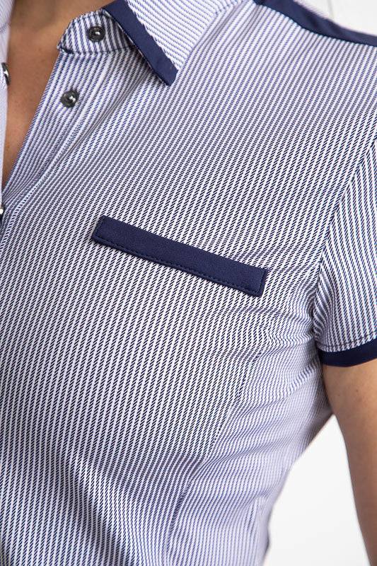 Close front view of the collar and front pocket on the Cute and Classic Short Sleeve Golf Top in Workin' It Stripe. This stripe pattern consists of navy blue stripes on a white background. This top also has navy blue accents around each sleeve, across the