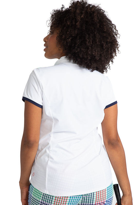Back view of the Cute and Classic Short Sleeve Golf Top in White. This top also has accents of Fairway Green across the top of each shoulder and across the top of the left front pocket. In addition, this shirt also has Navy Blue accents across the end of 