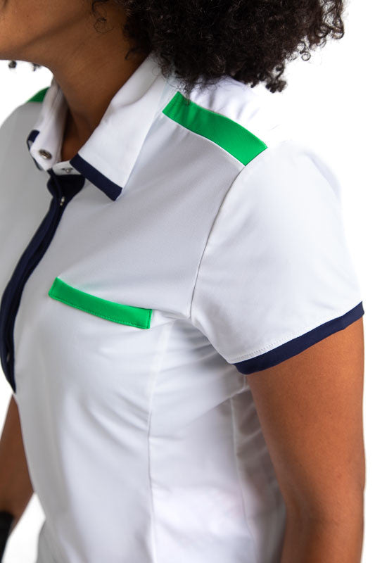 Close front and left side view of the Cute and Classic Short Sleeve Golf Top in White. This top also has accents of Fairway Green across the top of each shoulder and across the top of the left front pocket. In addition, this shirt also has Navy Blue accen