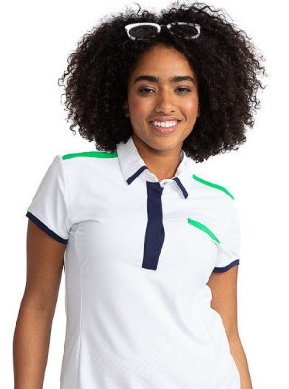 Smiling woman wearing the Cute and Classic Short Sleeve Golf Top in White. This top also has accents of Fairway Green across the top of each shoulder and across the top of the left front pocket. In addition, this shirt also has Navy Blue accents across th