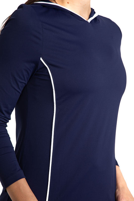 Tight front view of the Layer It Up Long Sleeve Hoodie Golf Top in Navy Blue. There are white accents around the edge of the hood and down each side of this hoodie.