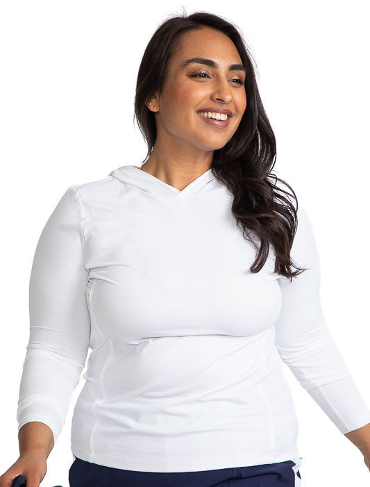Smiling woman wearing the Layer It Up Long Sleeve Hoodie Golf Top in White.