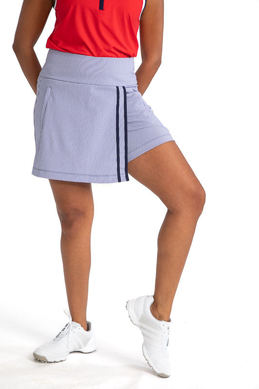 Complete front view of the Skort and Short Golf Skort in Workin' It Stripe. This stripe pattern consists of navy blue stripes on a white background. This skort has two vertical stripes down the left front side of the skort. 